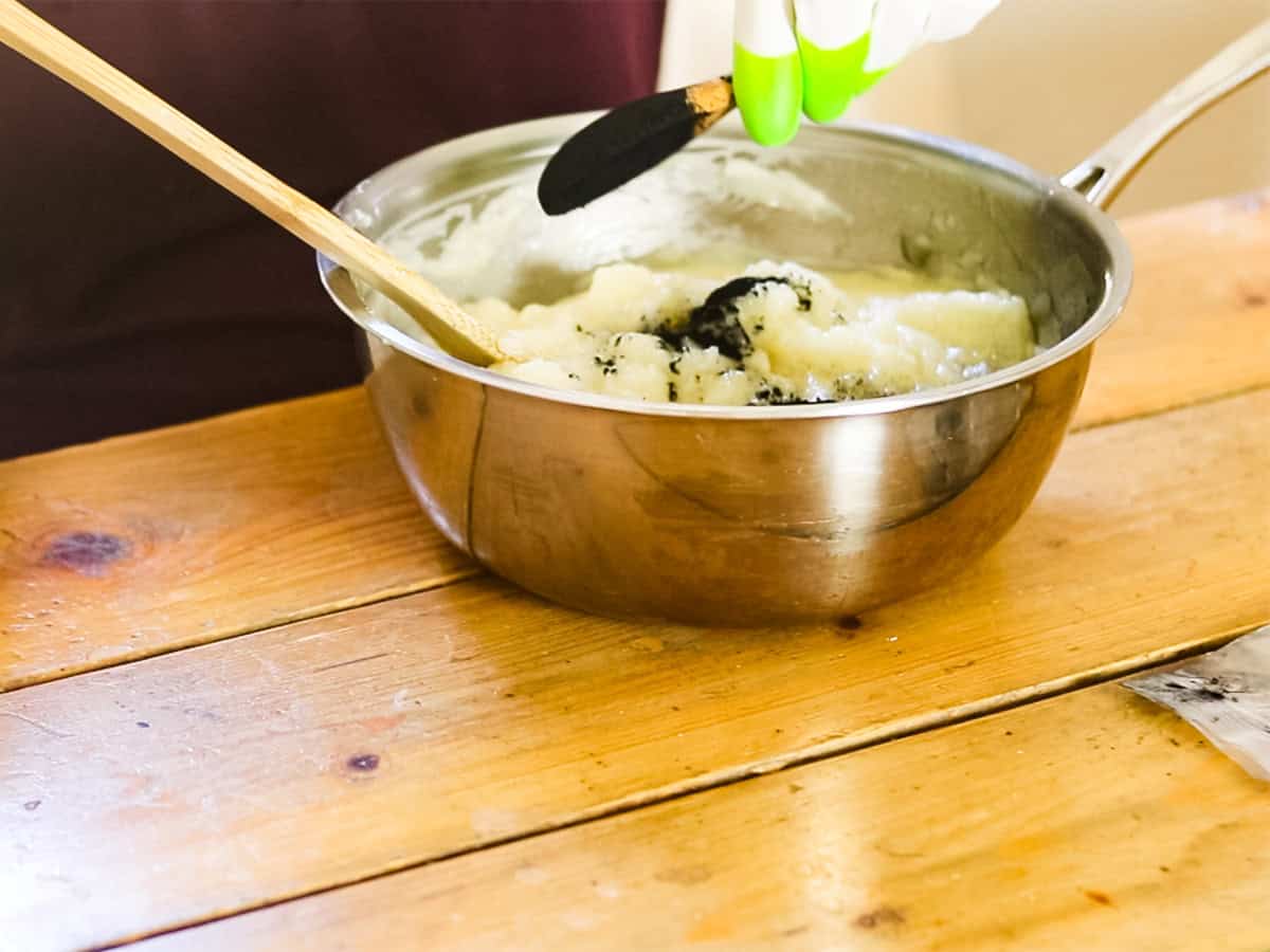 Mixing charcoal into soap mixture.