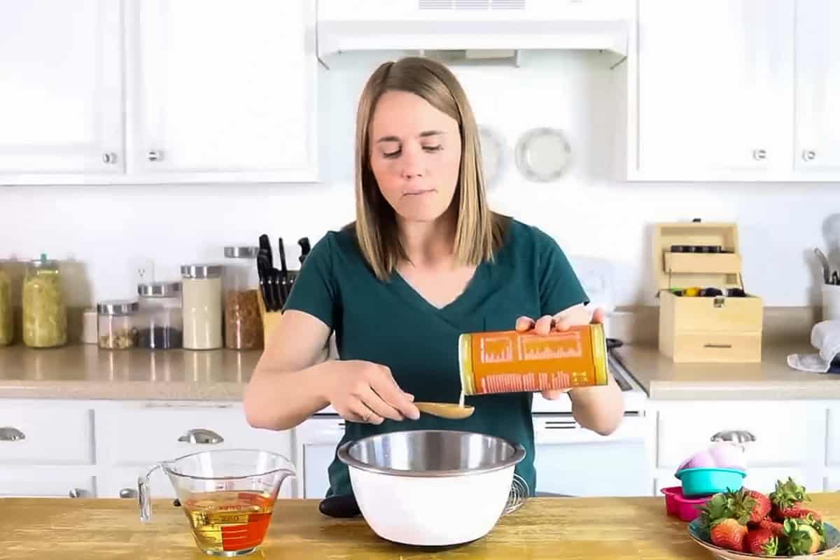 Pouring gelatin into a metal mixing bowl.