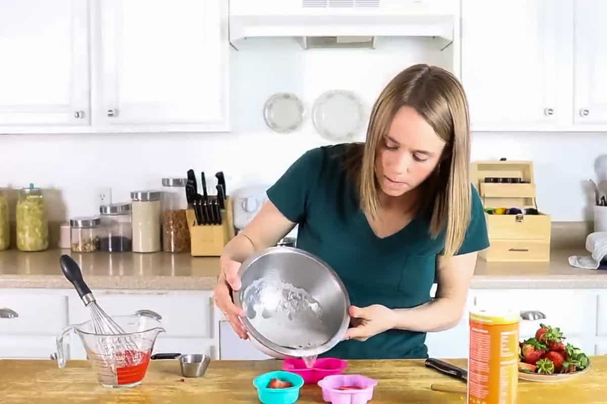 Pouring mixture into silicone molds.