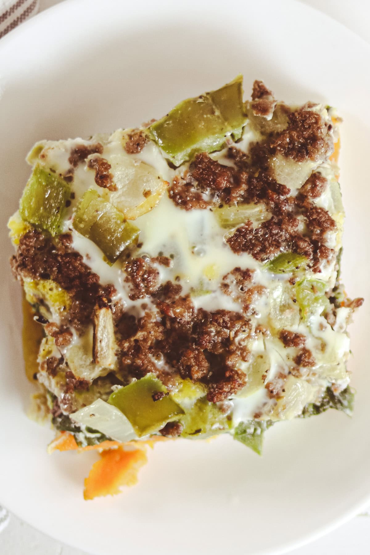 A slice of sweet potato breakfast casserole on a white plate.
