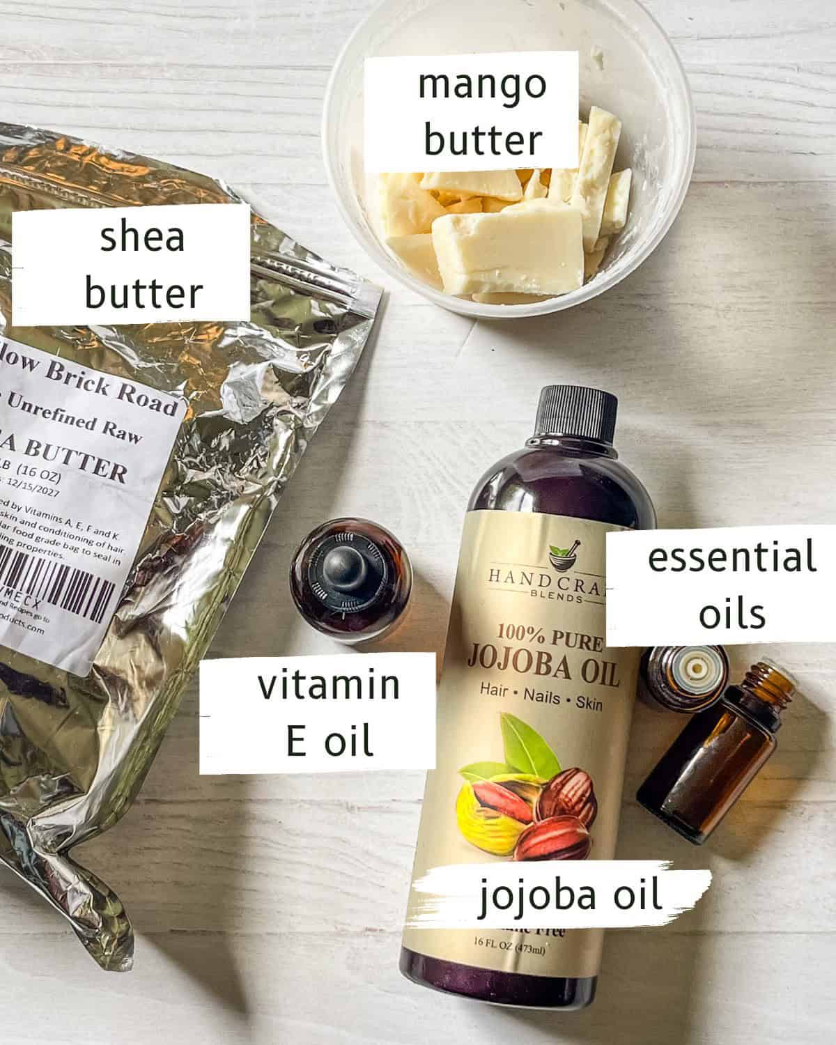 Labeled ingredients for homemade hand cream on a white, wooden table. 