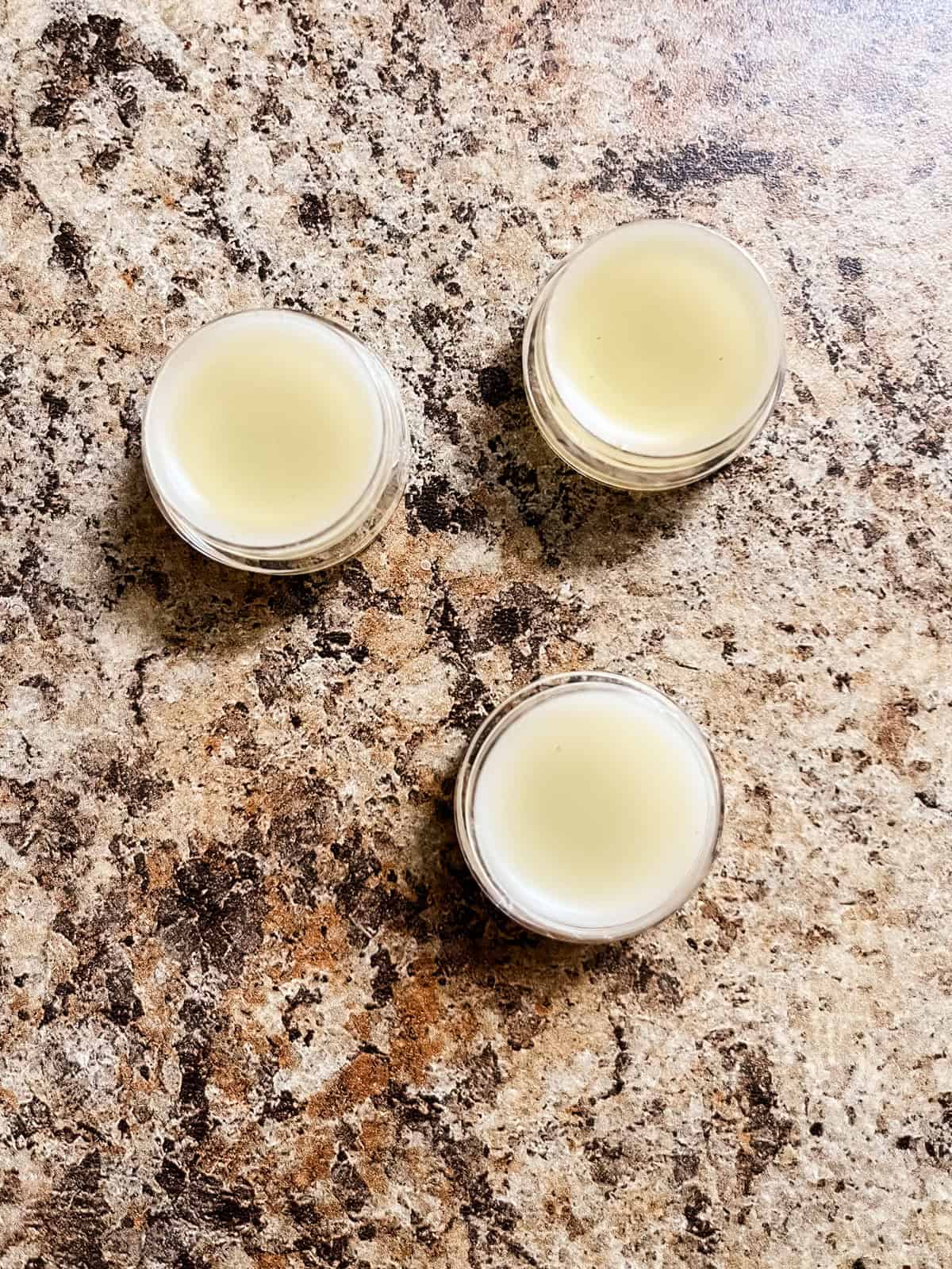 Tallow lip balm in lip balm containers.