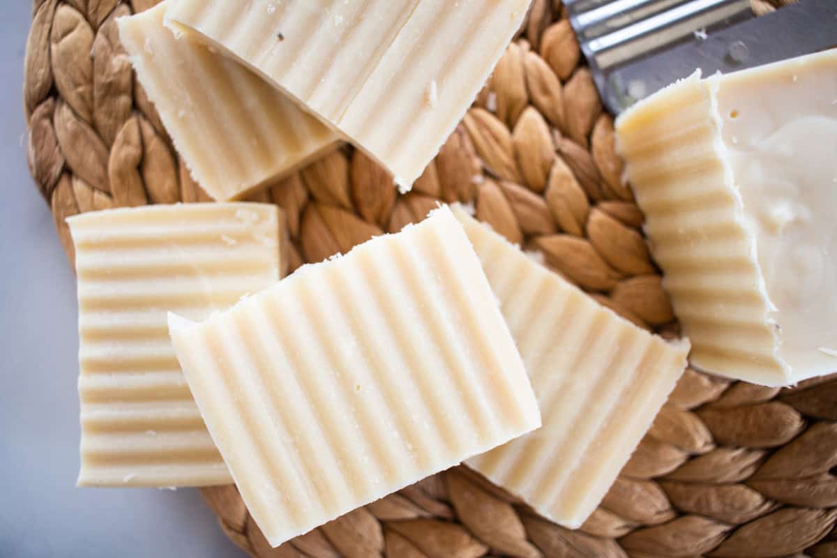 Beeswax soap bars on a wicker mat.