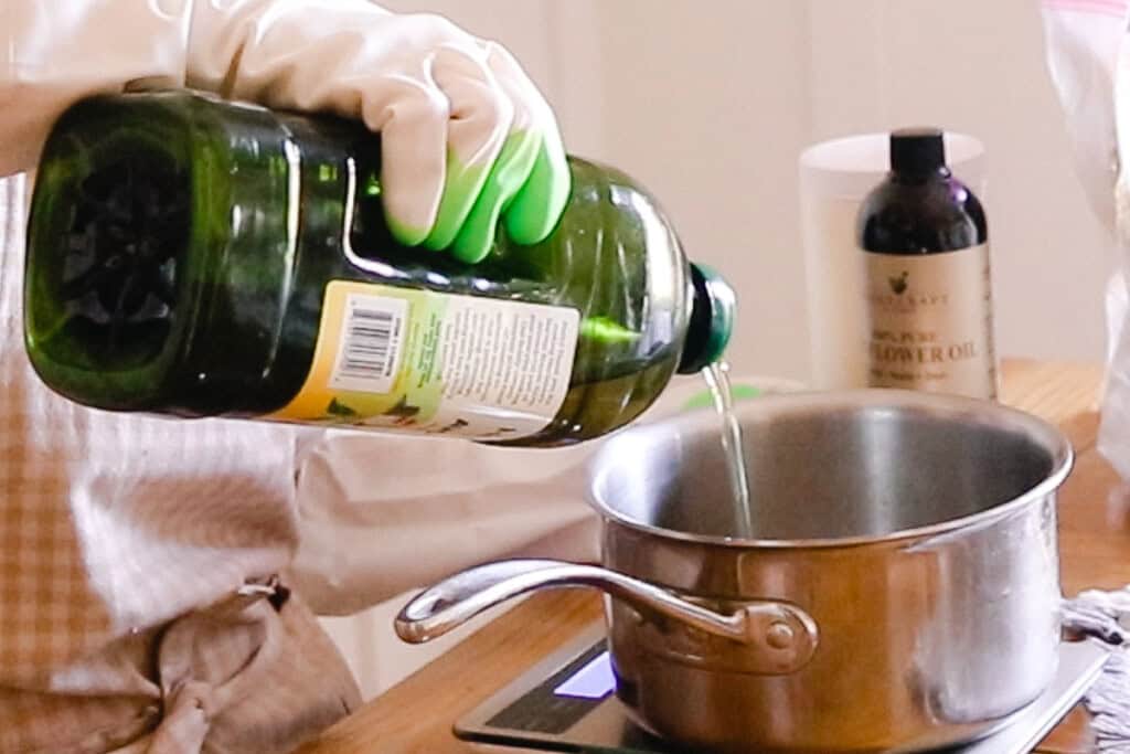 Pouring avocado oil into a saucepan.