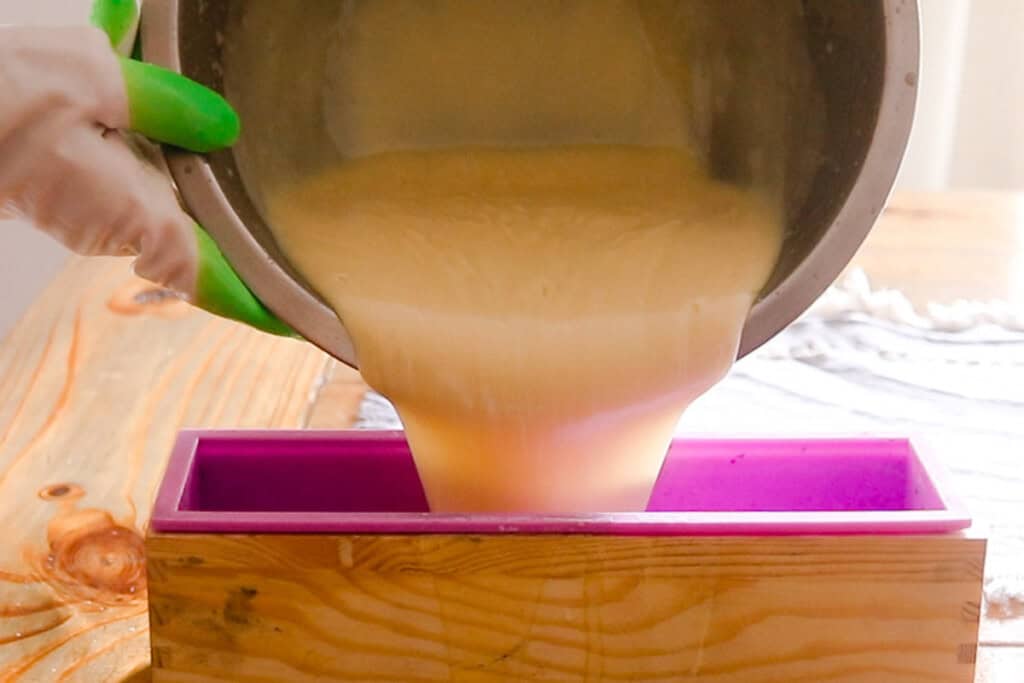 Pouring soap into a silicone soap mold.