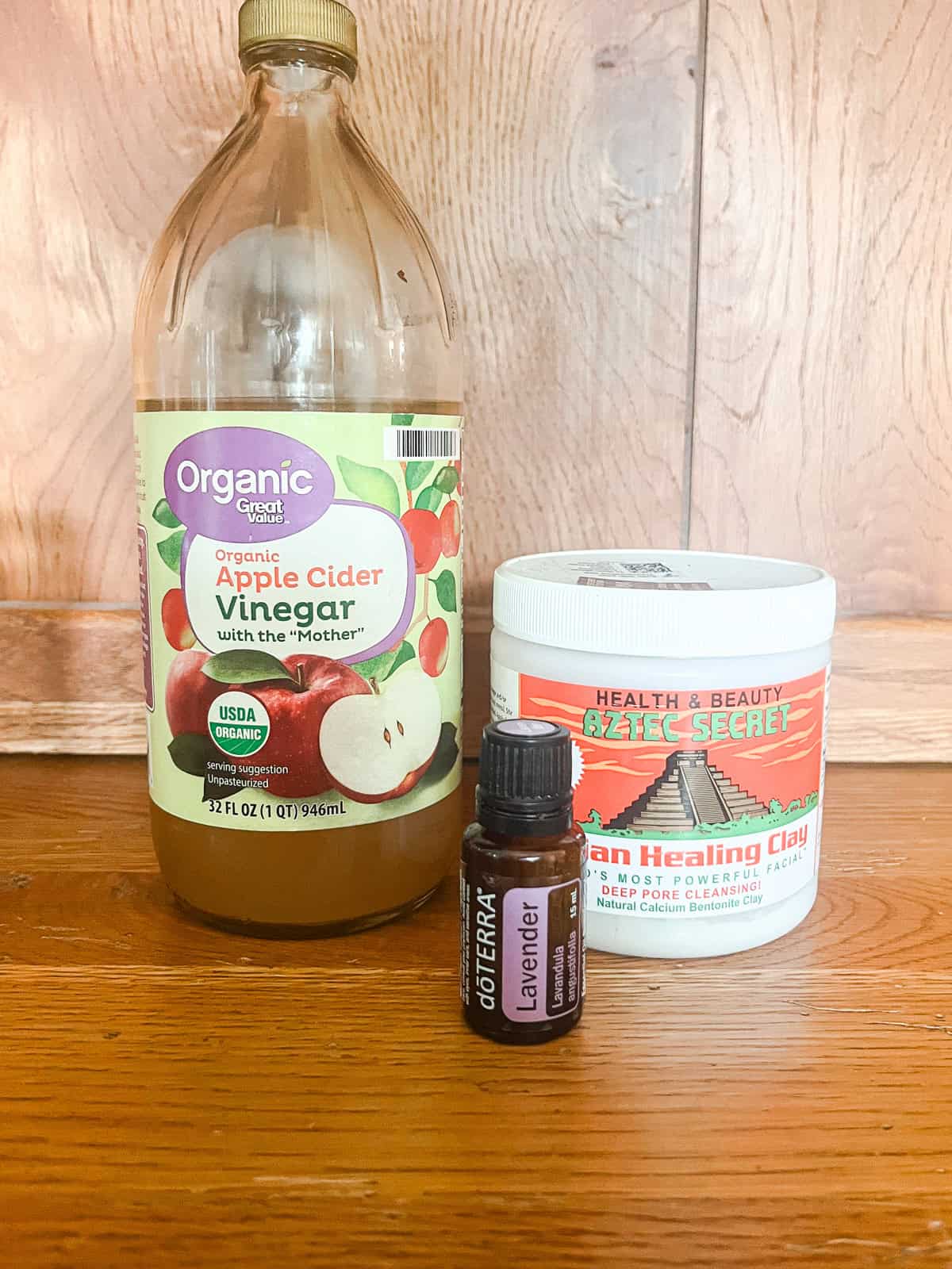 Bentonite clay face mask ingredients on a wooden table. 
