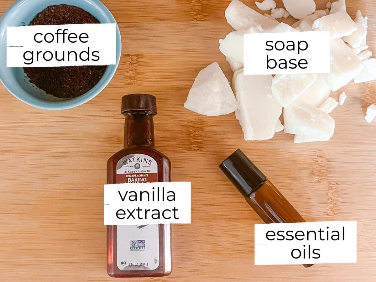 Goat milk soap bar ingredients labeled on a wooden tabletop.