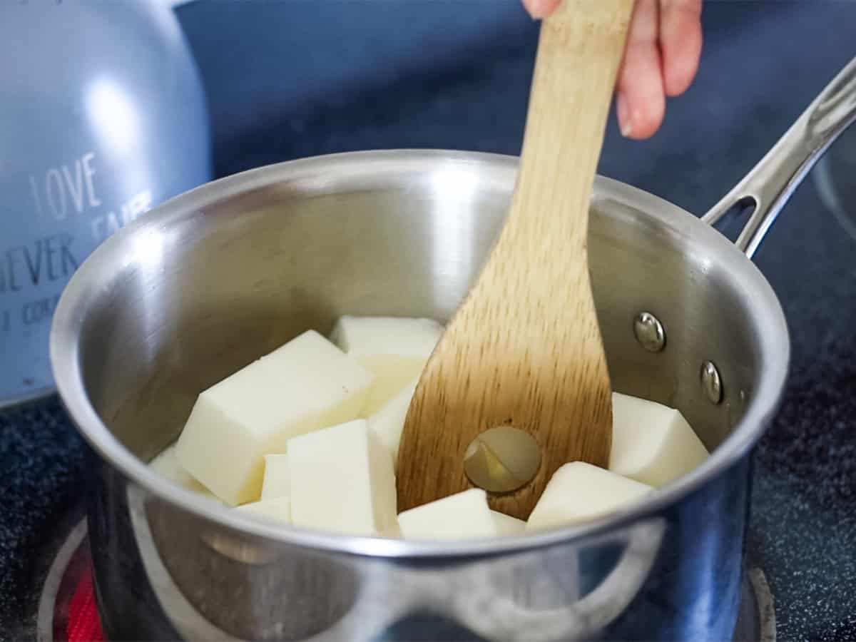 Melting cubes of goat milk soap base in a double boiler.