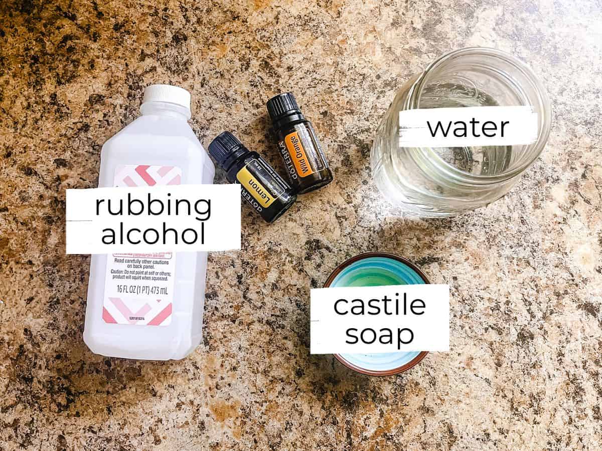 Homemade granite cleaner ingredients labeled on a kitchen countertop. 