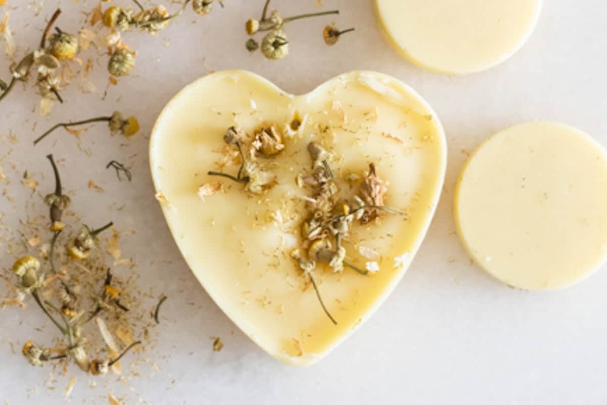 A heart-shaped wax air freshener next to dried florals and other wax air fresheners.