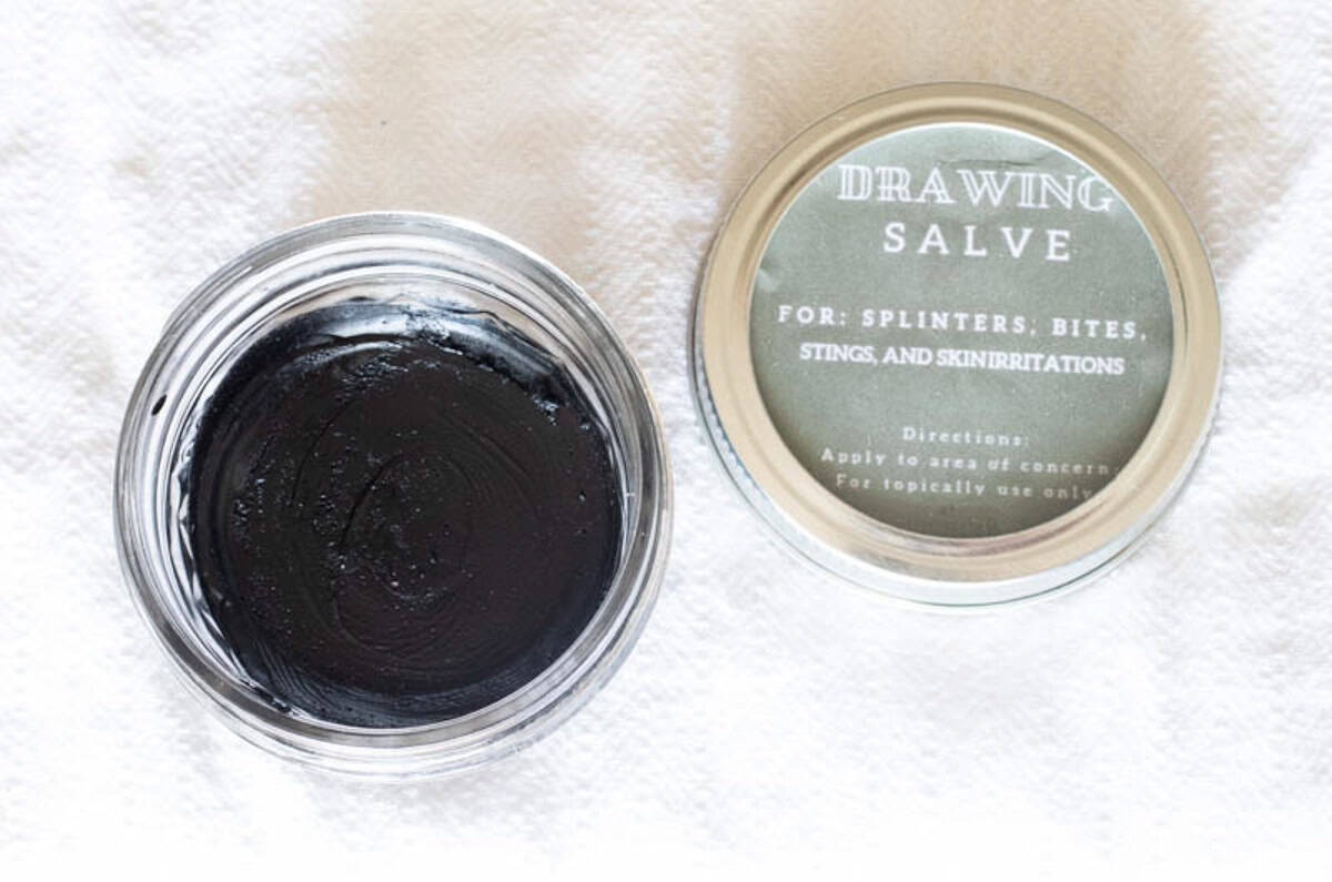 A jar of homemade drawing salve with a labeled lid.