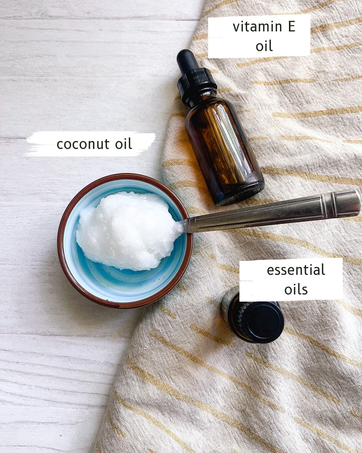 Homemade eye cream ingredients labeled on a white table.