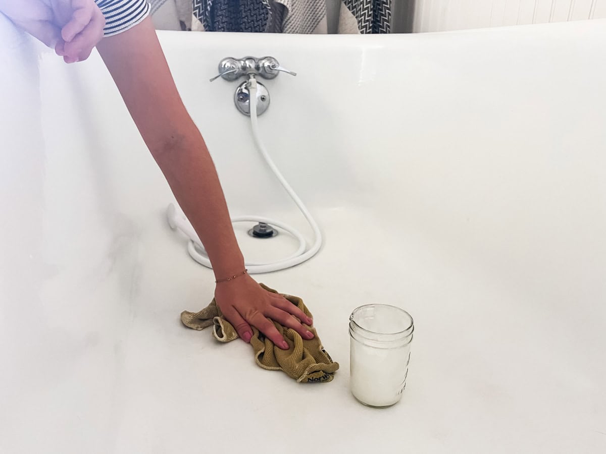 Scrubbing a bathtub with homemade bathtub cleaner.