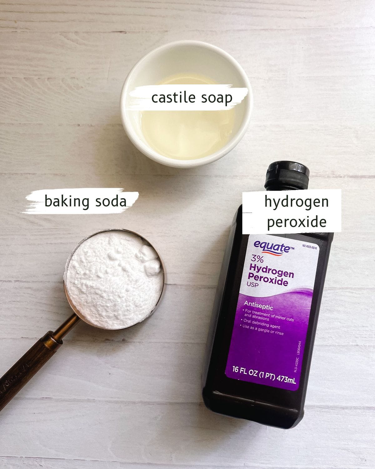 Ingredients for DIY bathtub cleaner labeled on a white table.