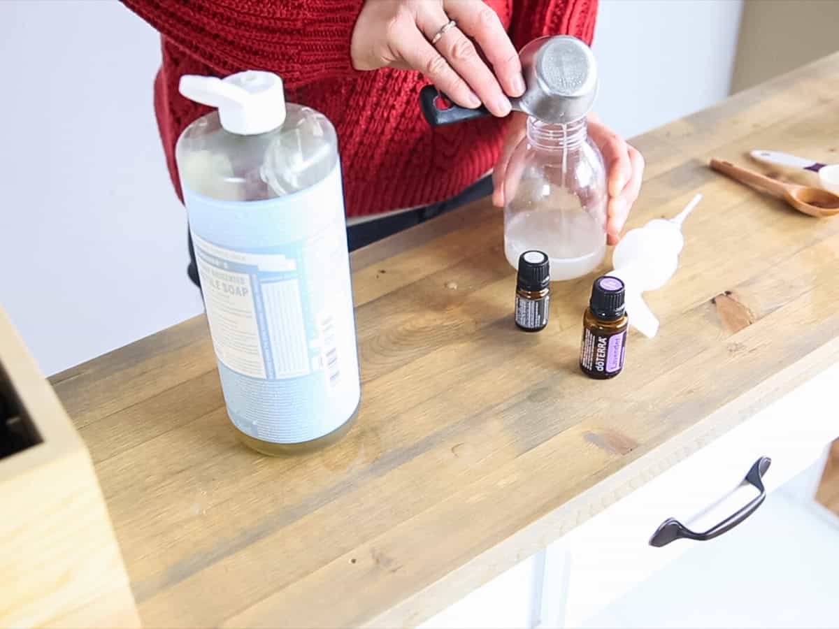 Pouring castile soap into a foaming soap dispenser.