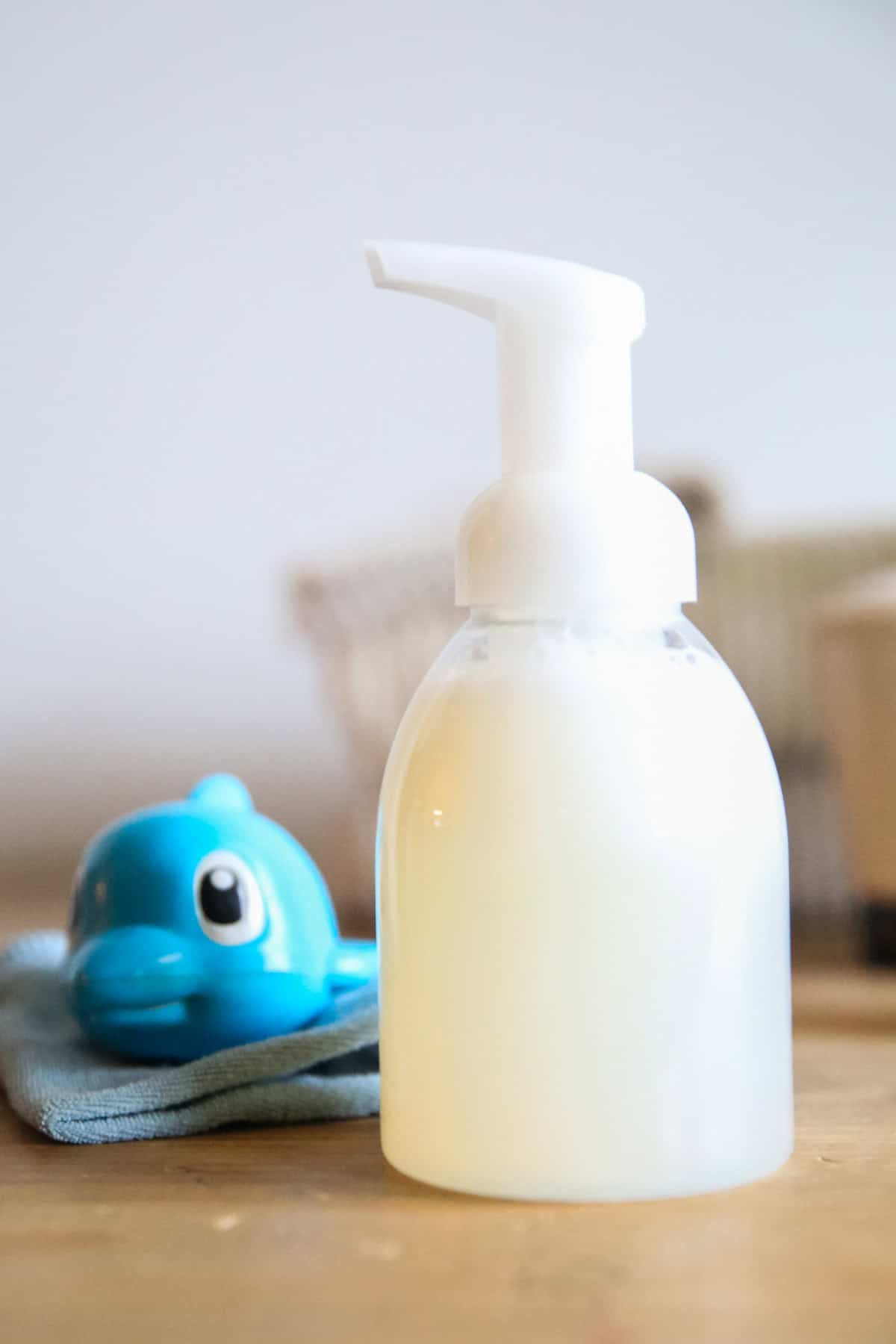 A bottle of all natural baby wash and a bath toy.
