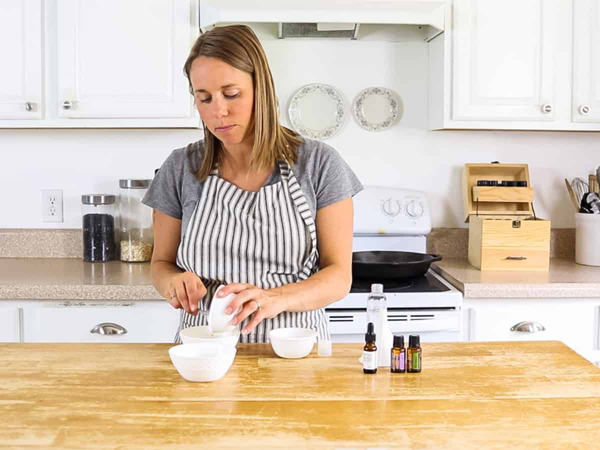 Pouring ingredients in a white bowl.