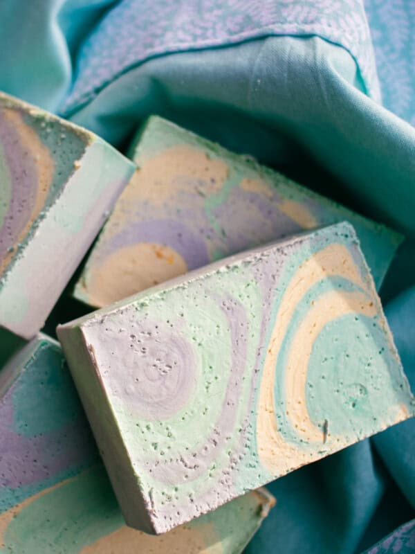 Colorful olive oil soap bars on a blue towel.