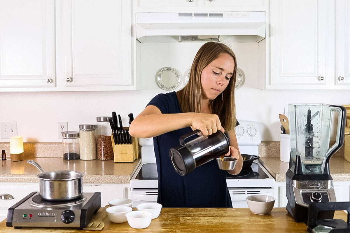 Pouring coffee into a measuring cup.