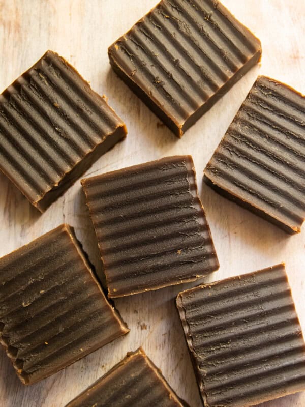 Homemade pine tar soap spread out on a wooden table.