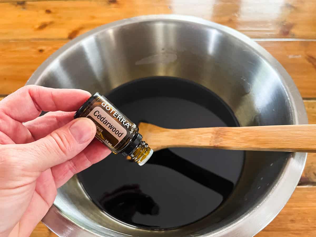 Dropping essential oils into the bowl of melted soap mixture.