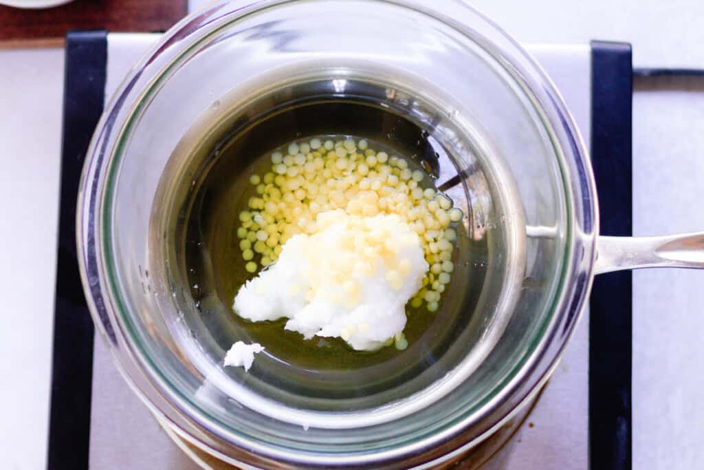 Hair pomade ingredients melting in a double boiler.