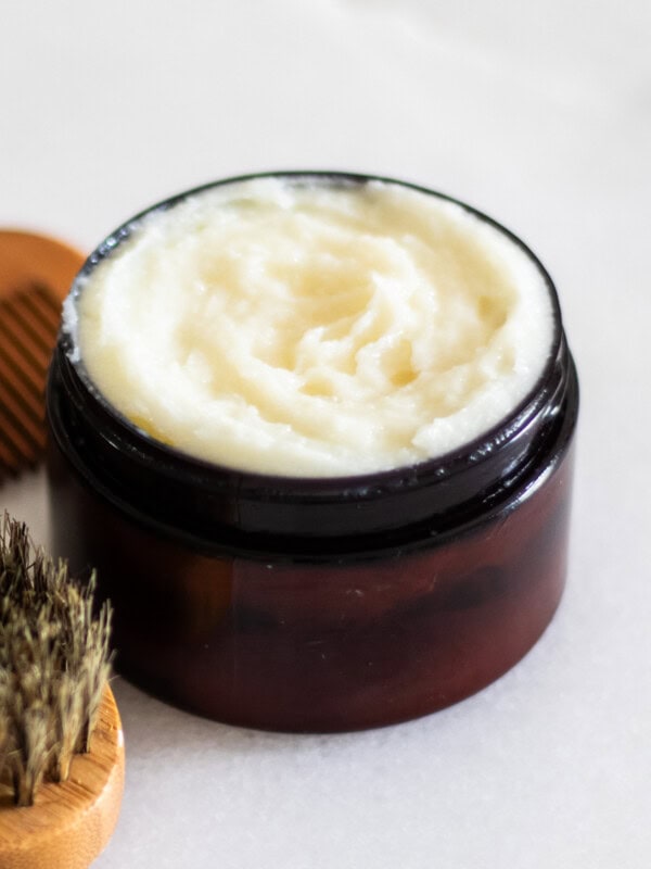 Beard conditioning balm in an amber jar.
