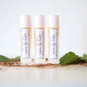 Homemade lip balm in reusable lip balm tubs with homemade labels.