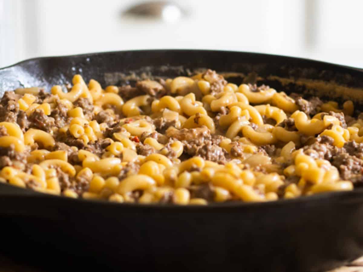 A cast iron skillet full of gluten-free hamburger helper. 