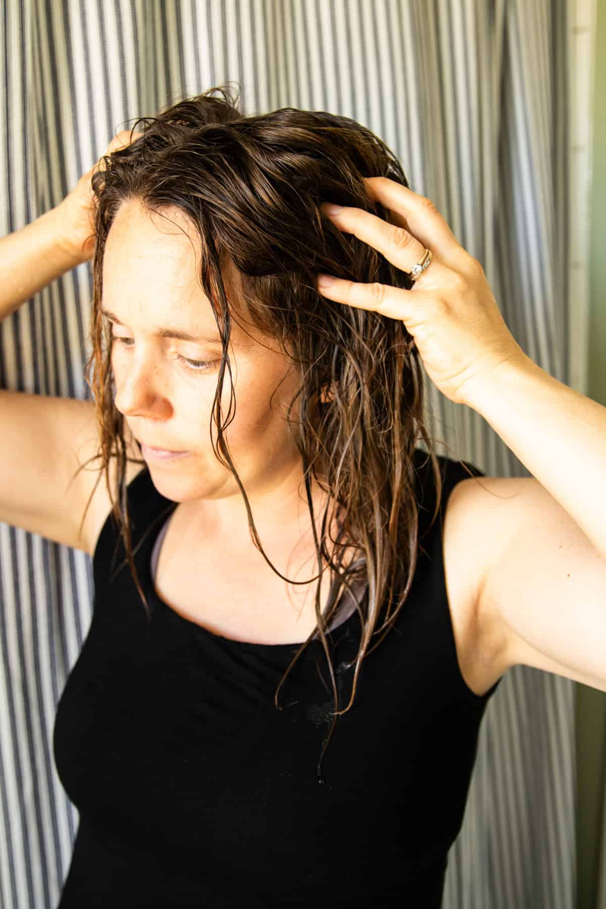 Massaging baking soda hair rinse into the hair and scalp. 