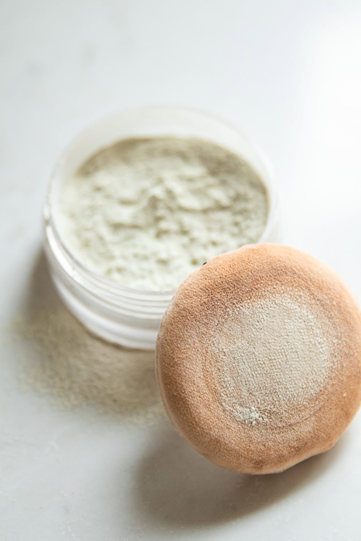 DIY body powder in a shaker jar with a powder puff. 