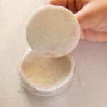 DIY body powder in a jar with a powder puff.