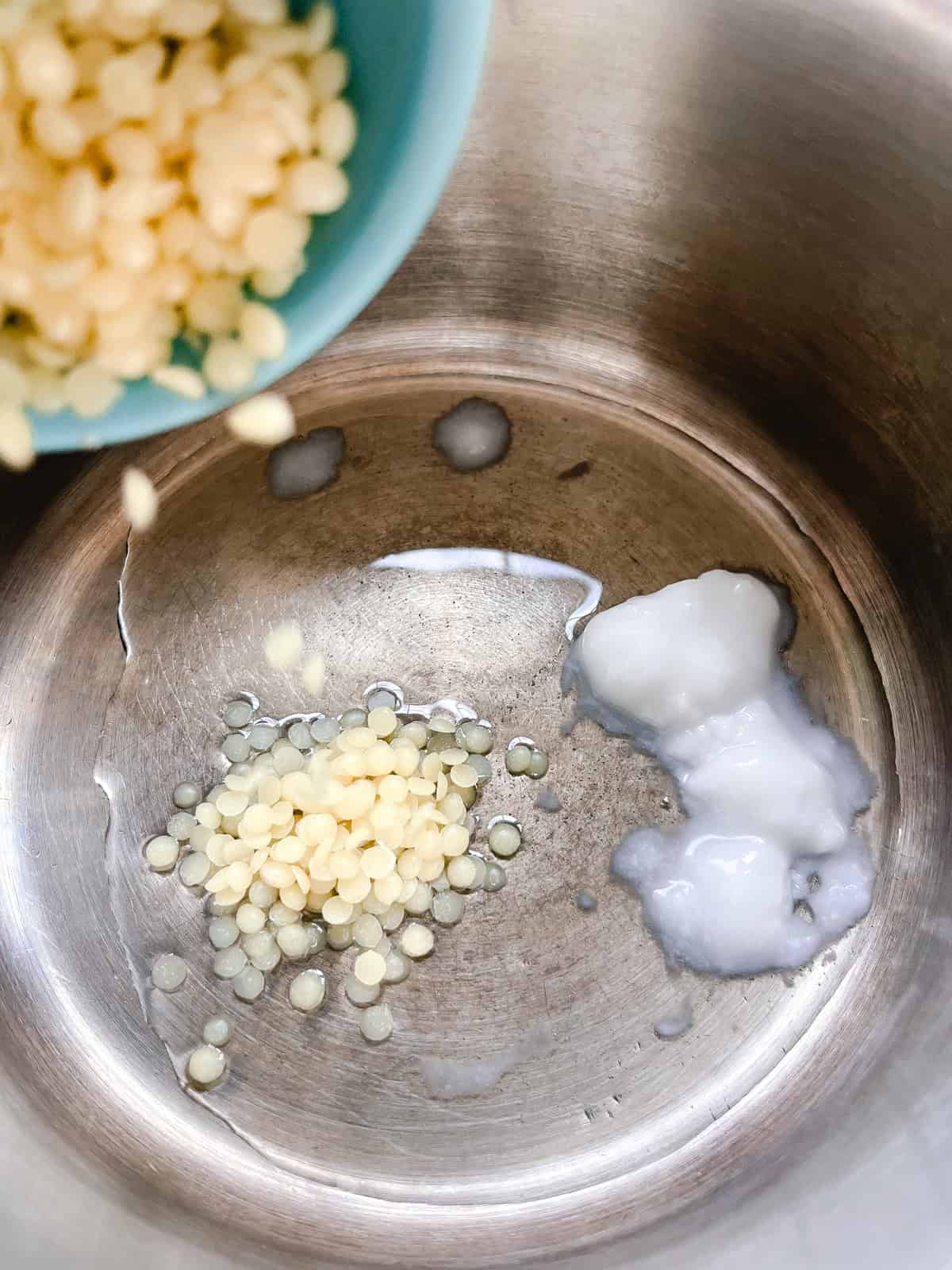 Adding ingredients to a double boiler. 