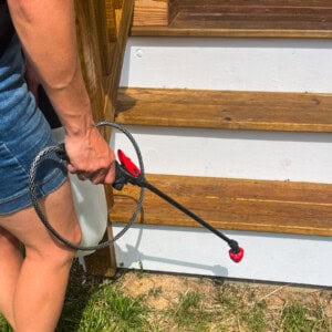 Spraying natural weed killing on a patch of weeds with a pump sprayer.