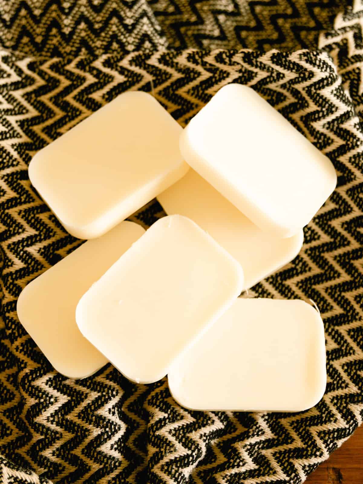 Solid conditioner bars on a patterned towel.