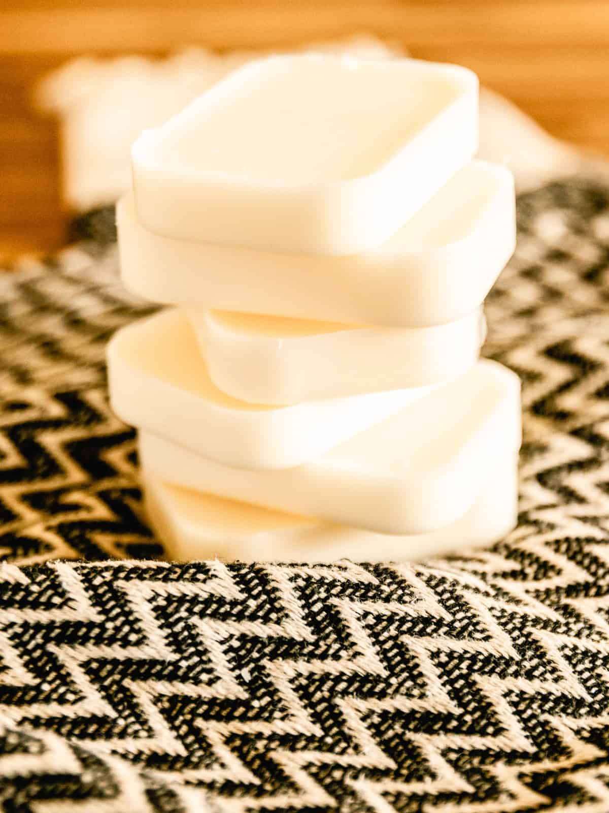A stack of conditioner bars on a patterned towel. 