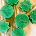 Mint lime soap bars spread out on a linen.