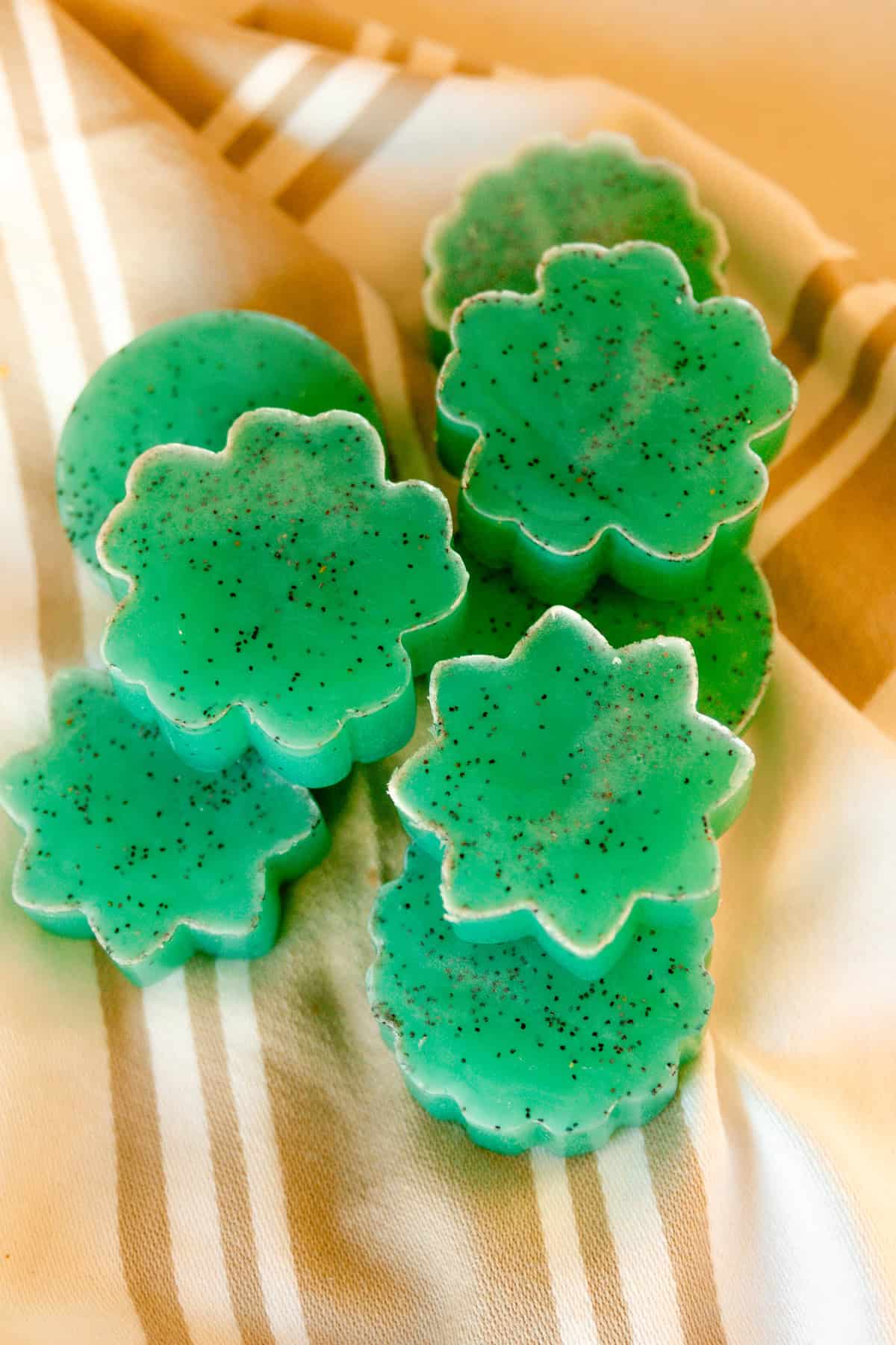 Mint lime melt and pour soap bars stacked on a linen.