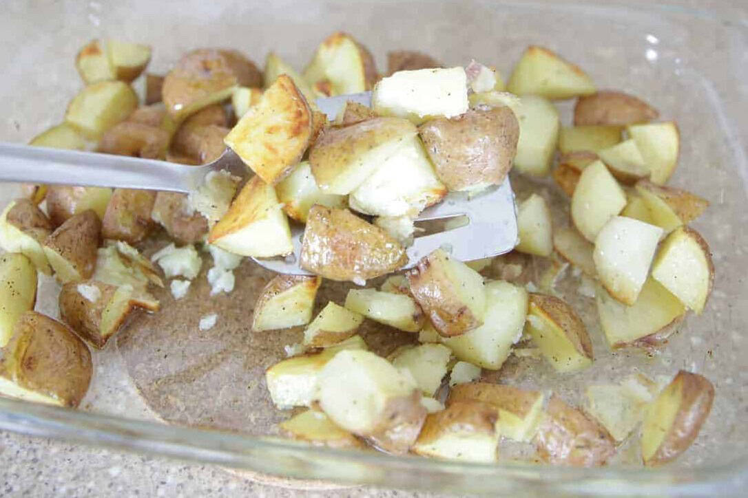 Oven roasted rosemary potatoes in a glass baking dish.