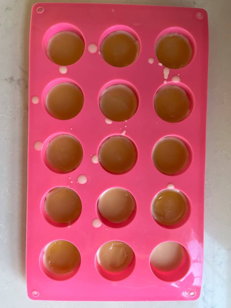 A silicone mold filled with melted wax.
