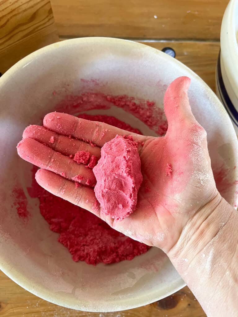 Holding a ball of bath bomb mixture to show it holding its shape.